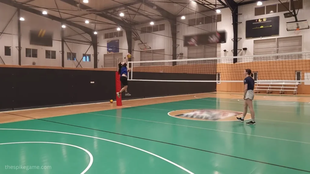 Volleyball player practicing solo spike drills against a wall
